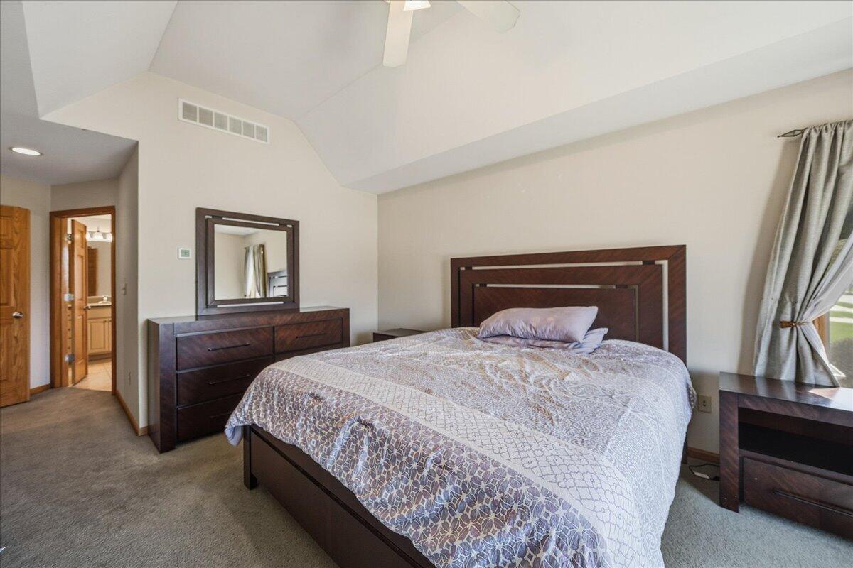 9741 Whitehall Garden Munster, IN 46321 - Photo 19 of 30 a bedroom with a large bed and a chandelier