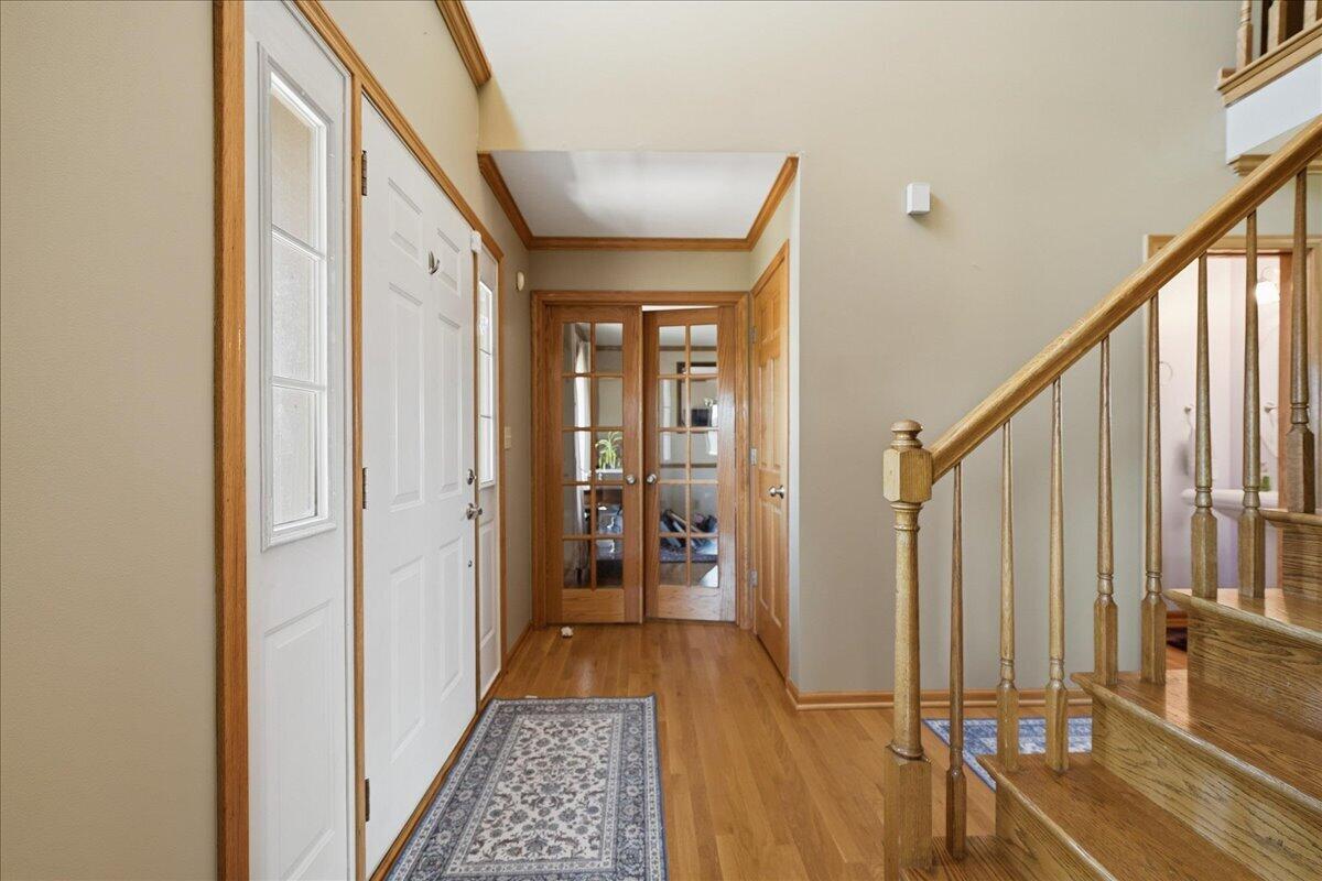 9741 Whitehall Garden Munster, IN 46321 - Photo 7 of 30 a view of hallway with wooden floor and stairs