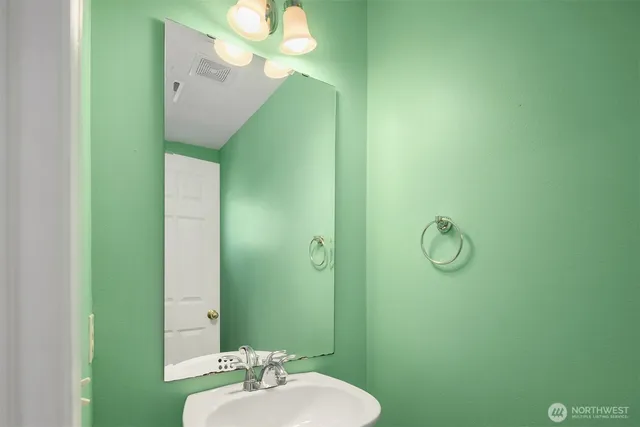 a bathroom with a sink and mirror