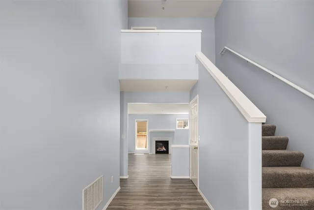 a view of a hallway view with wooden floor and staircase