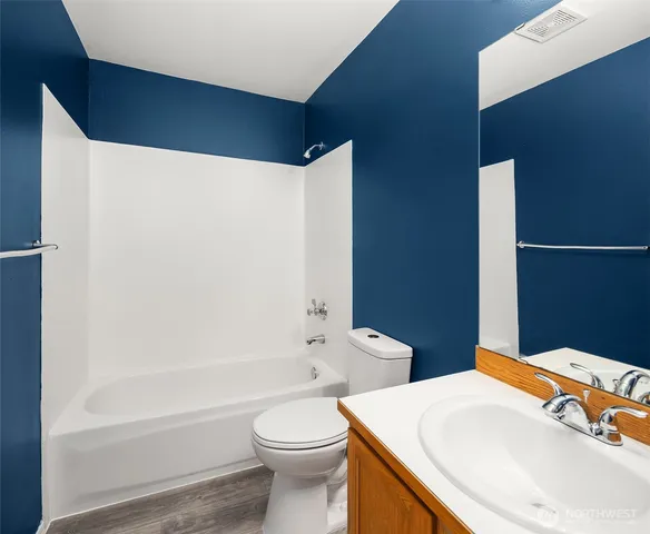 a bathroom with a sink a toilet and bathtub