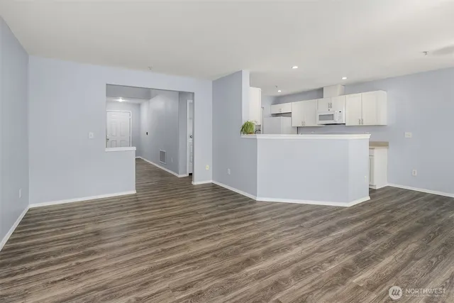 a view of a kitchen with wooden floor and a sink