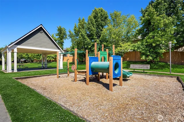 a view of fire pit with large trees