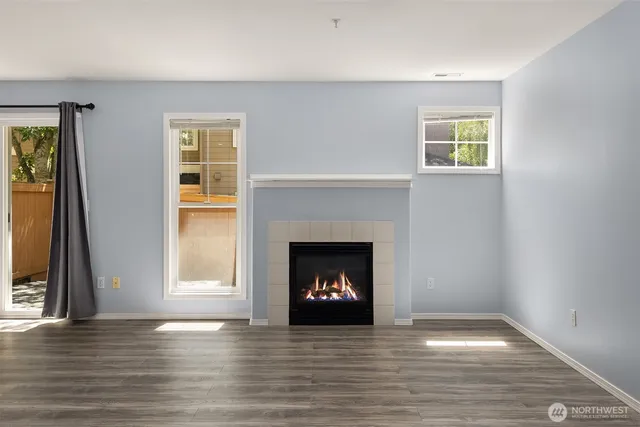 a living room with a fireplace and a window