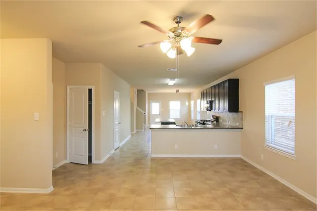 a view of a kitchen with a sink and a window