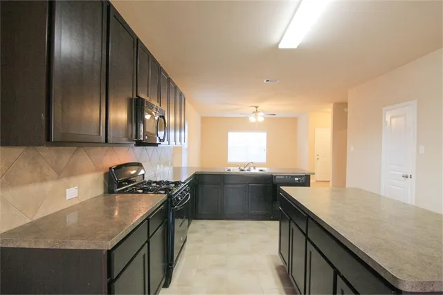 a kitchen with a sink and stove