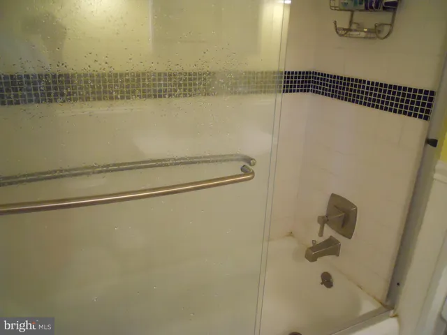 a kitchen with granite countertop white cabinets and stainless steel appliances