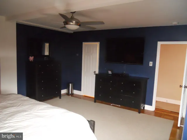 a bedroom with a bed and a dresser