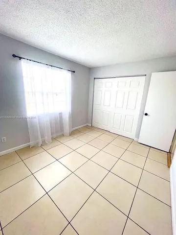 a view of a hallway to rooms