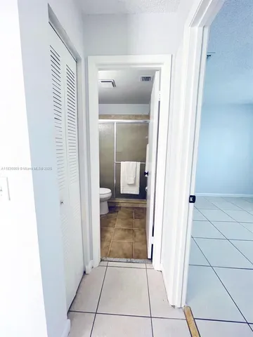 a bathroom with a toilet sink mirror and vanity