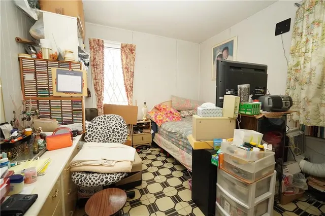 a bedroom with furniture and a large window