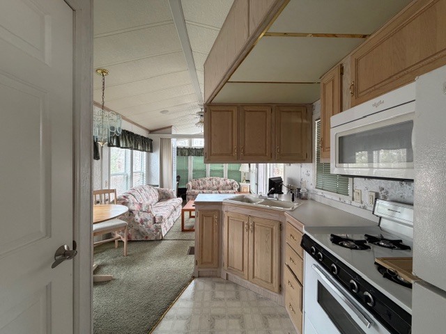 2795 East 28th Road Marseilles, IL 61341 - Photo 12 of 64 a kitchen with a stove a sink and a refrigerator