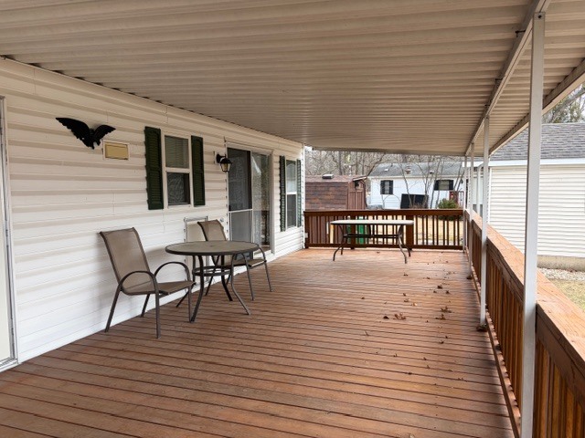 2795 East 28th Road Marseilles, IL 61341 - Photo 21 of 64 a view of a patio with table and chairs with wooden floor and fence