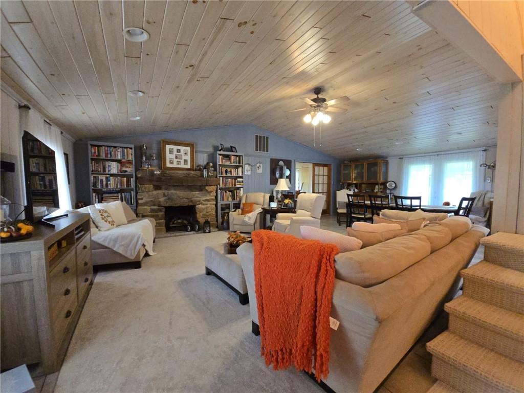 1405 Madison Road Templeton, PA 16259 - Photo 12 of 50 a living room with furniture a fireplace and a flat screen tv