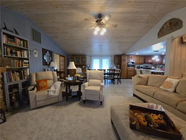 a living room with furniture and a book shelf