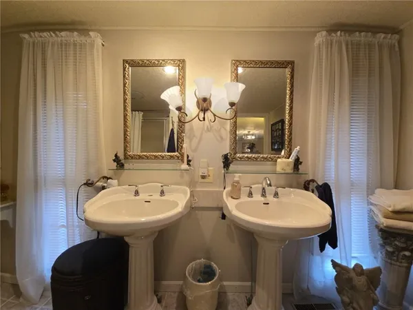 a bathroom with 2 sink and a mirror