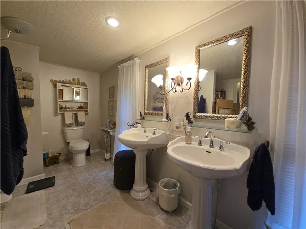 a bathroom with a sink and mirror with toilet