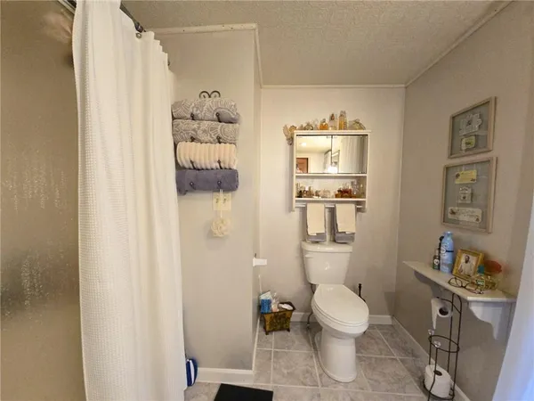a bathroom with a toilet a sink and shower