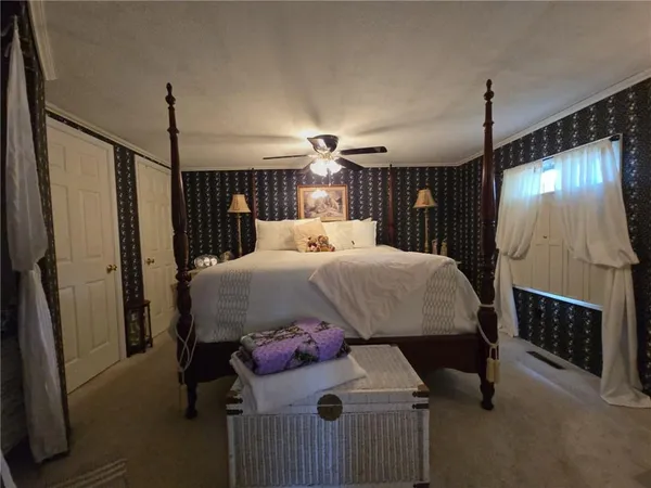 a bedroom with a bed window and a table