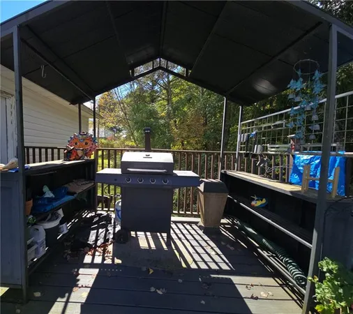 a view of a patio with dining table and chairs with wooden floor