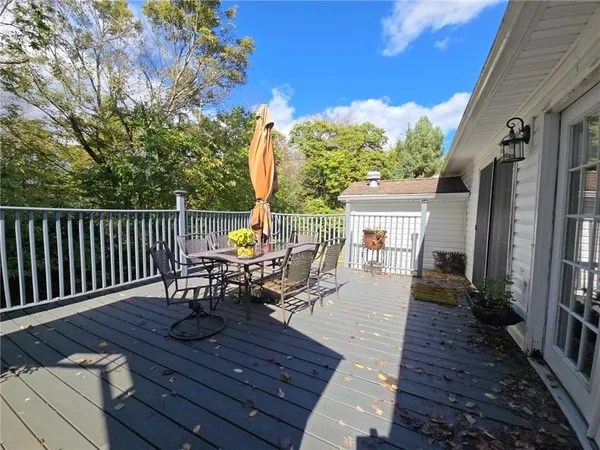 a view of a patio with table and chairs potted plants with wooden floor