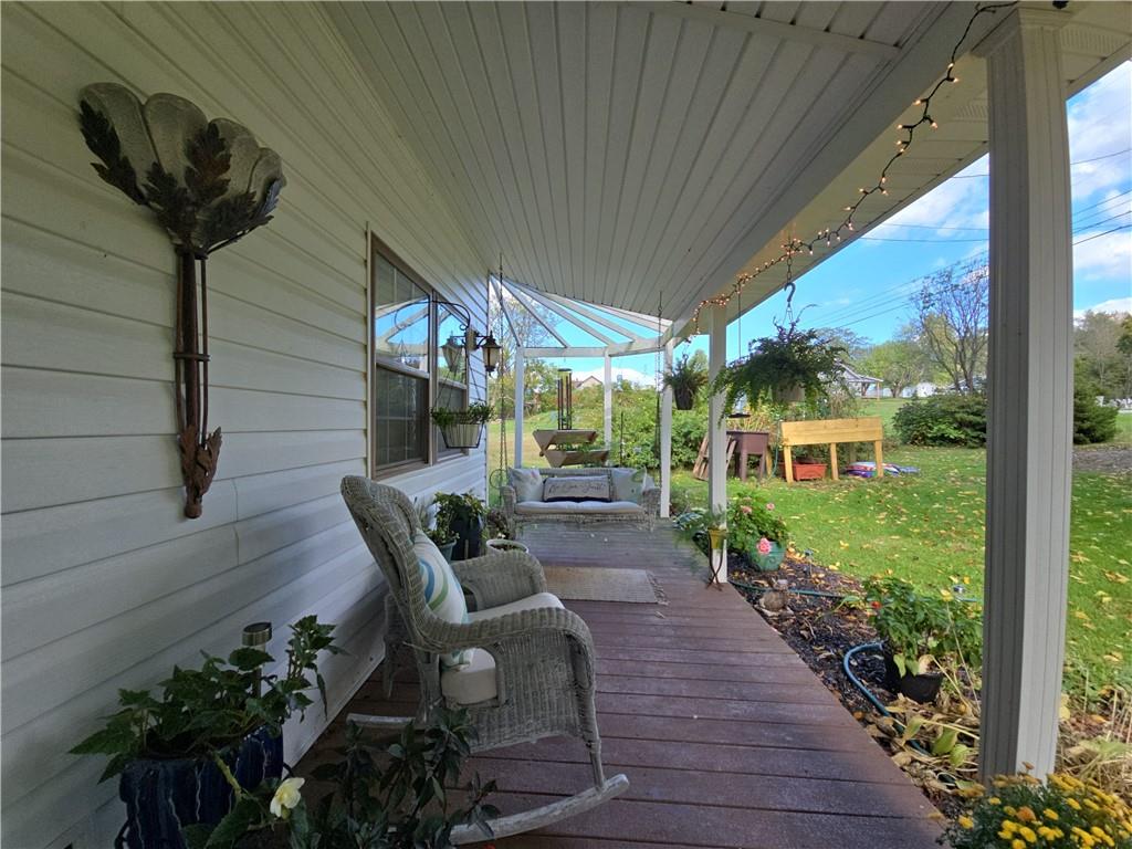 1405 Madison Road Templeton, PA 16259 - Photo 44 of 50 a view of a patio with table and chairs potted plants with wooden floor