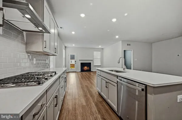 a kitchen with stove and cabinets