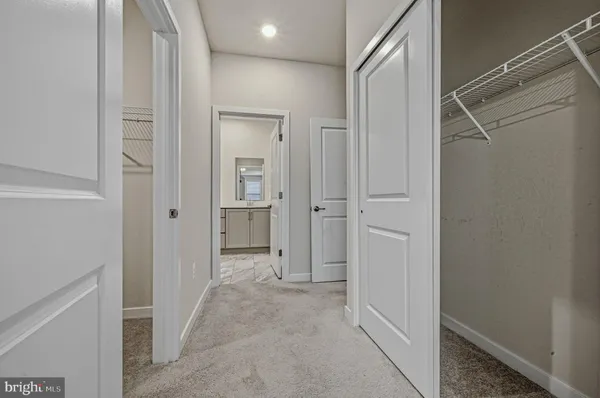 a view of a hallway with closet and wooden floor