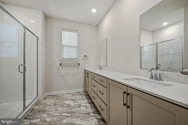 a bathroom with a double vanity sink and mirror