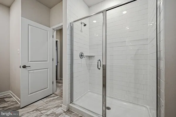 a bathroom with a glass shower door