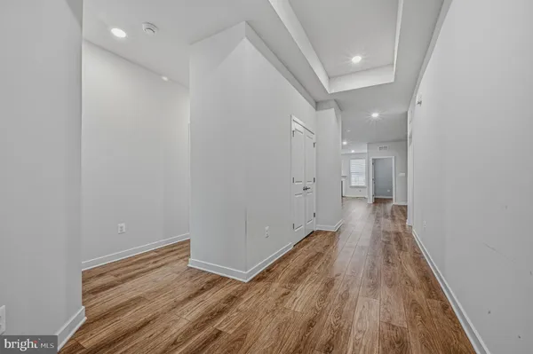 a view of hallway with wooden floor