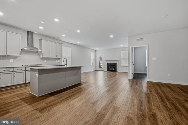 a large kitchen with stainless steel appliances granite countertop a large counter top a sink and a stove