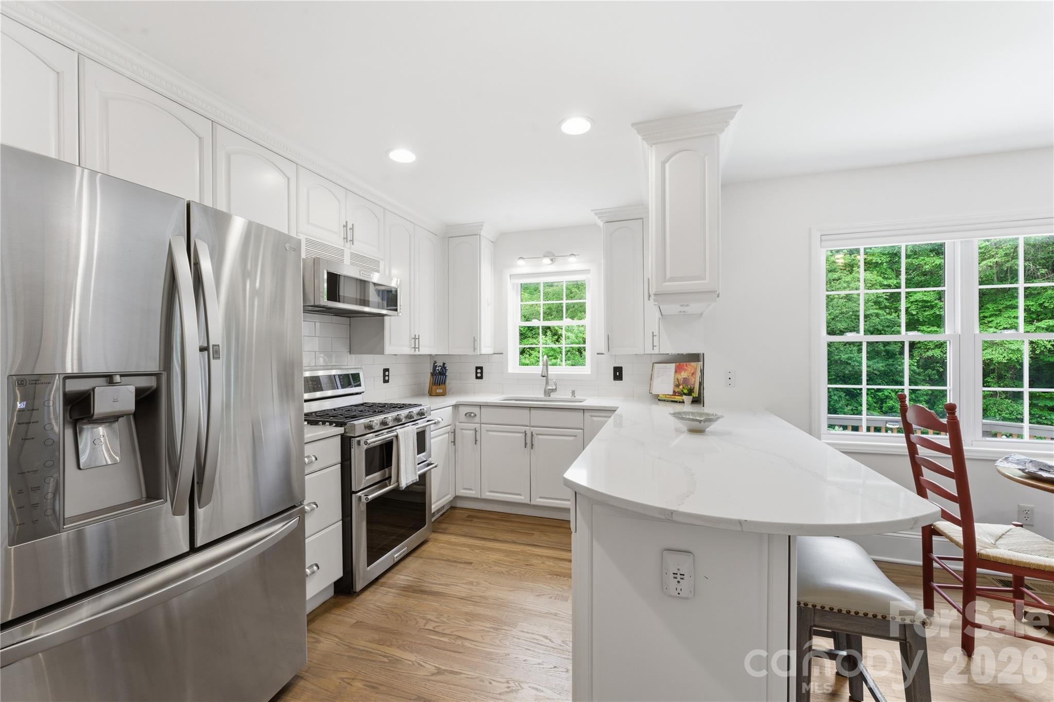 15 Raccoon Point Canton, NC 28716 - Photo 17 of 48 a large kitchen with a large window and stainless steel appliances