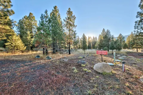 a backyard of a house with fire pit and outdoor seating
