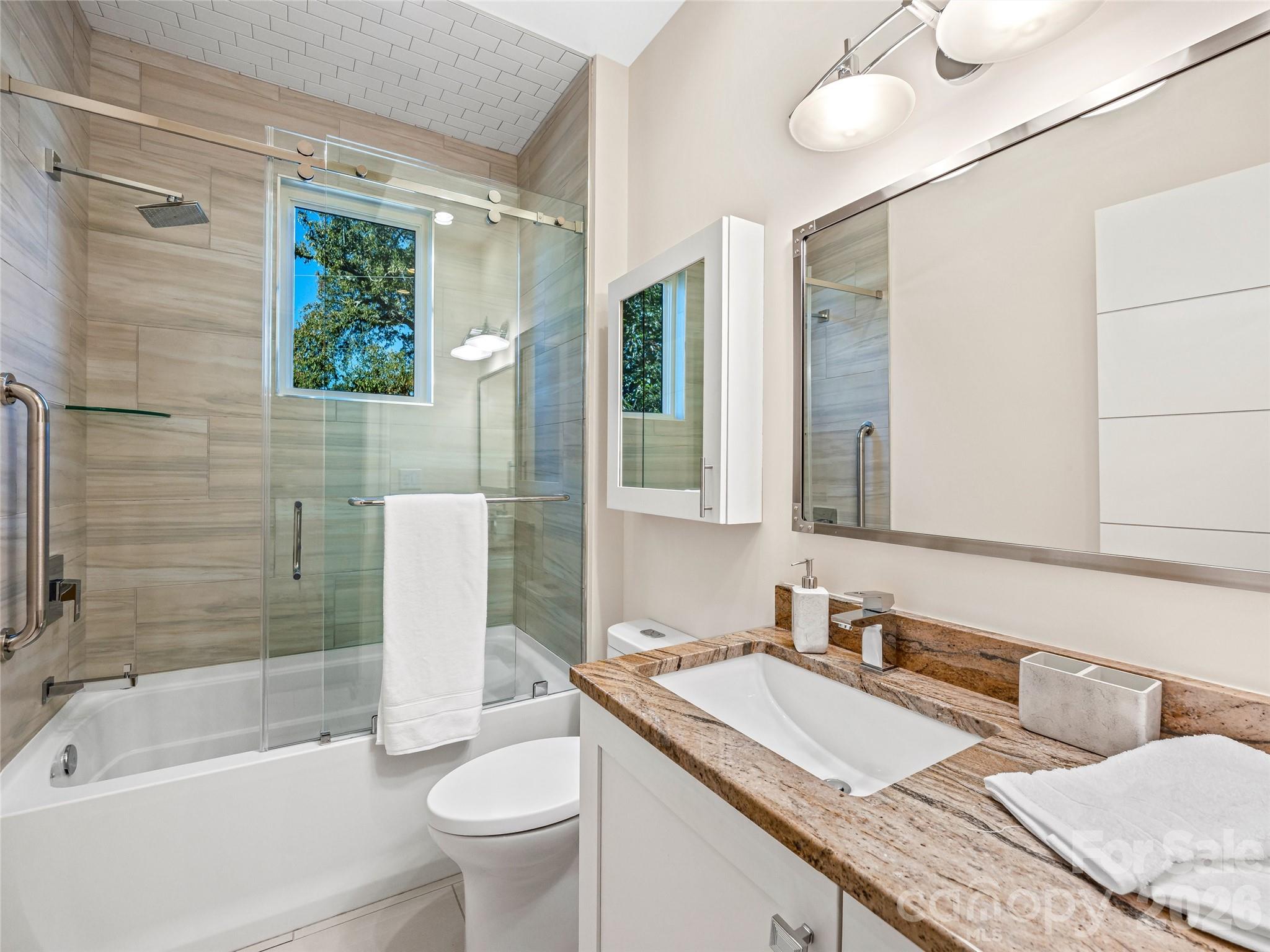 95 Horizon Hill Road Asheville, NC 28804 - Photo 29 of 47 a bathroom with a granite countertop sink mirror vanity and toilet