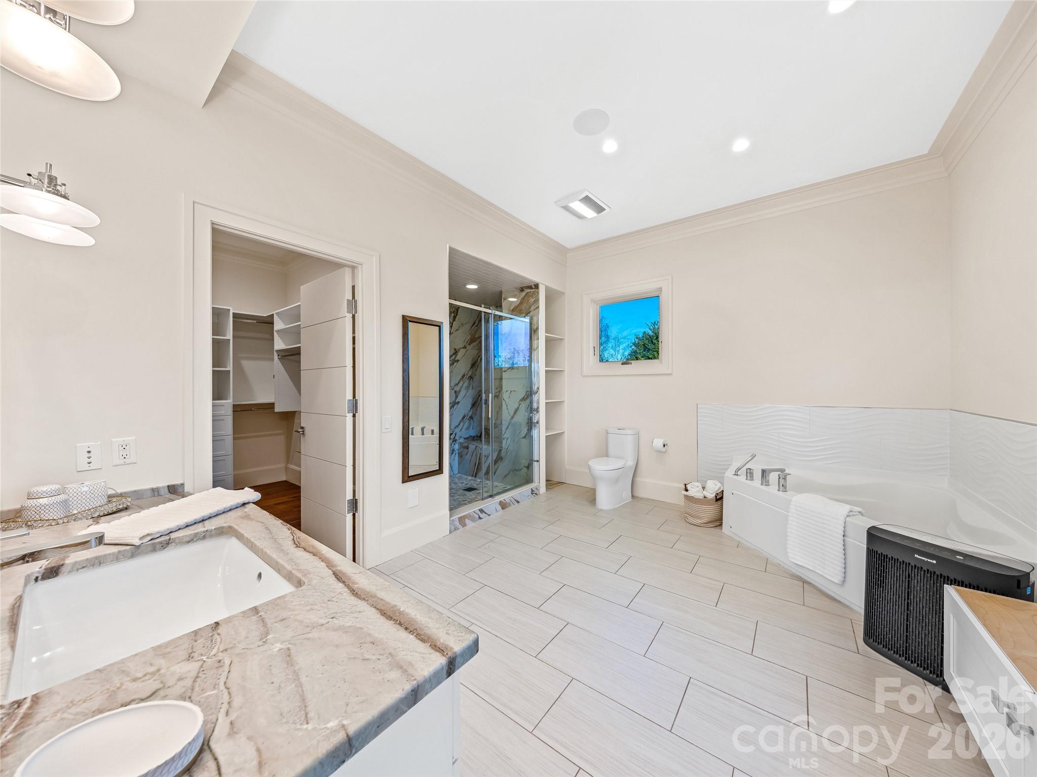 95 Horizon Hill Road Asheville, NC 28804 - Photo 34 of 47 a spacious bathroom with a granite countertop sink and a mirror