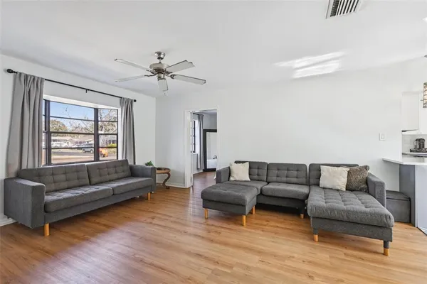 a living room with furniture and a large window