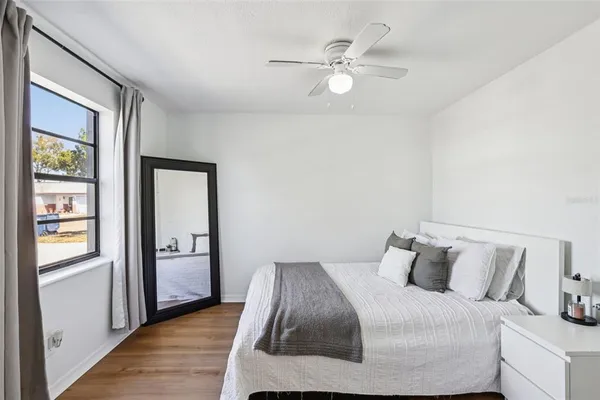 a bedroom with a bed and window