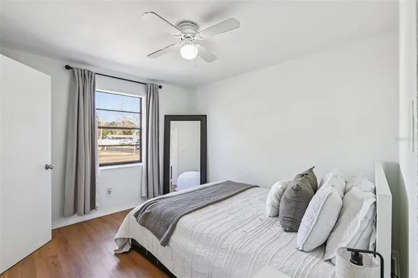 a bedroom with a bed and a window