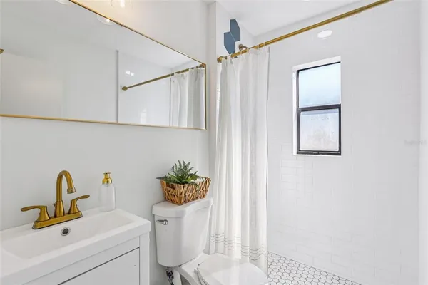 a bathroom with a sink toilet and a mirror