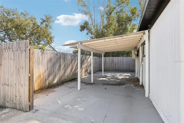 a backyard of a house with barbeque oven and outdoor seating