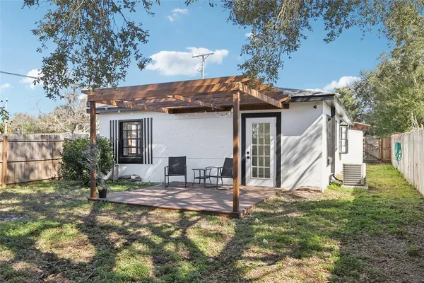 a view of a house with backyard and sitting area