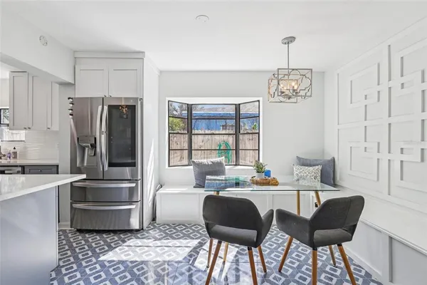 a kitchen with stainless steel appliances kitchen island granite countertop a refrigerator and a stove top oven