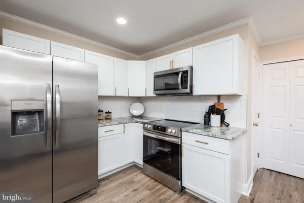 a kitchen with a refrigerator stove and sink