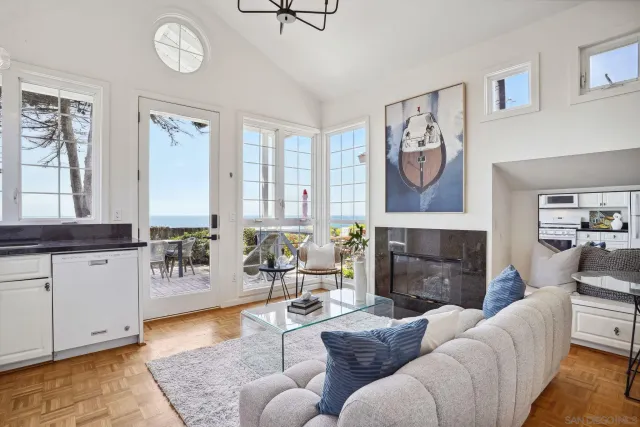 a kitchen with stainless steel appliances kitchen island granite countertop a stove a sink dishwasher a refrigerator and white cabinets with wooden floor