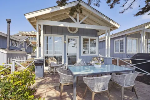a view of an house with backyard and sitting area
