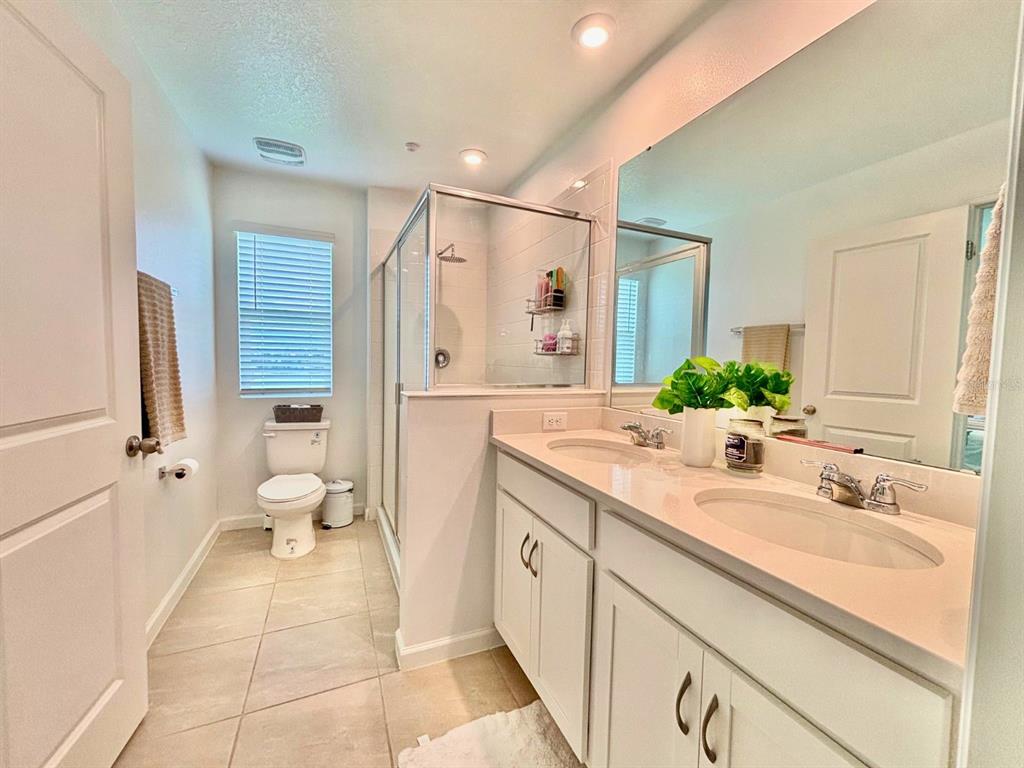 1005 Spring Palms Loop Orlando, FL 32828 - Photo 11 of 29 a spacious bathroom with a granite countertop sink mirror and a toilet