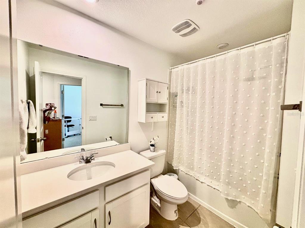 1005 Spring Palms Loop Orlando, FL 32828 - Photo 17 of 29 a bathroom with a sink vanity mirror and toilet