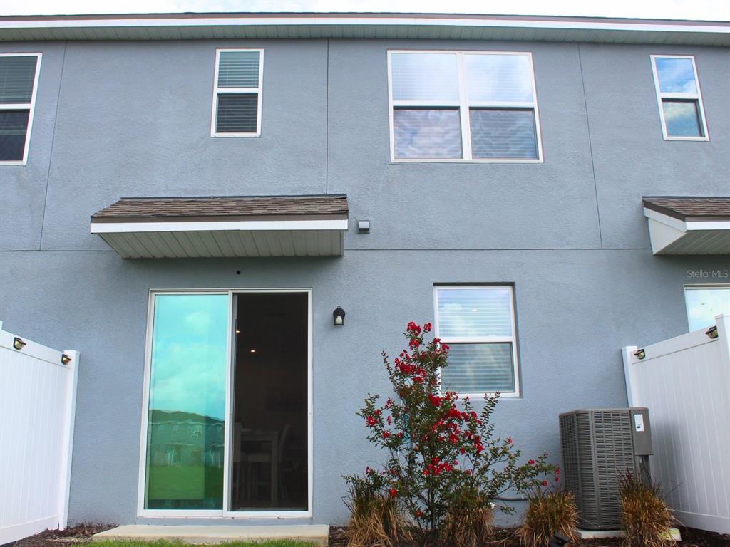 1005 Spring Palms Loop Orlando, FL 32828 - Photo 23 of 29 a potted plant sitting in front of a house