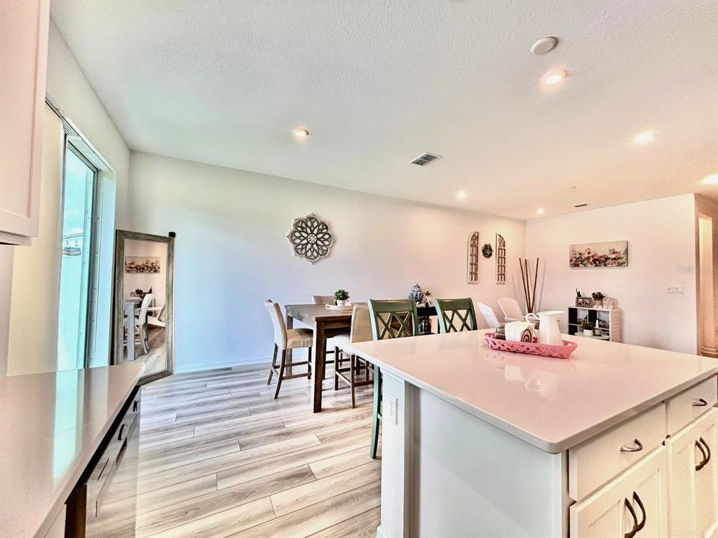 1005 Spring Palms Loop Orlando, FL 32828 - Photo 5 of 29 a view of a room that has a table and chairs in it